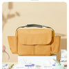 A tan multifunctional design bag used as a stroller cup and bottle holder with baby wipes nearby.