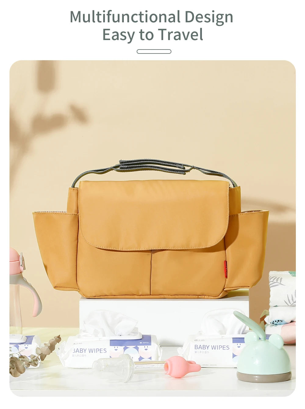 A tan multifunctional design bag used as a stroller cup and bottle holder with baby wipes nearby.