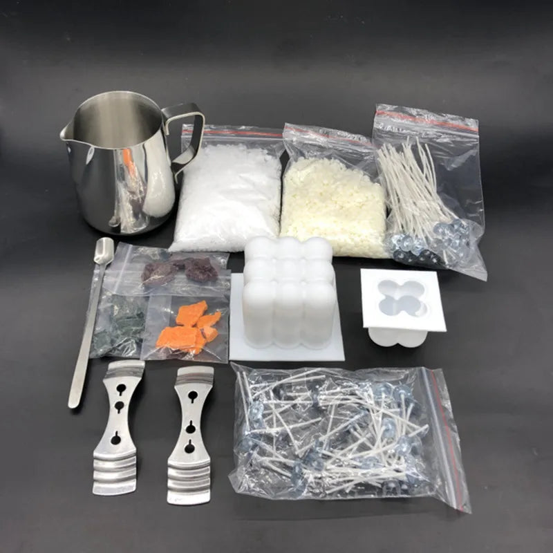 A complete candle making kit showing a metal pouring pot, various wicks and fixators in plastic bags, and wax pieces.