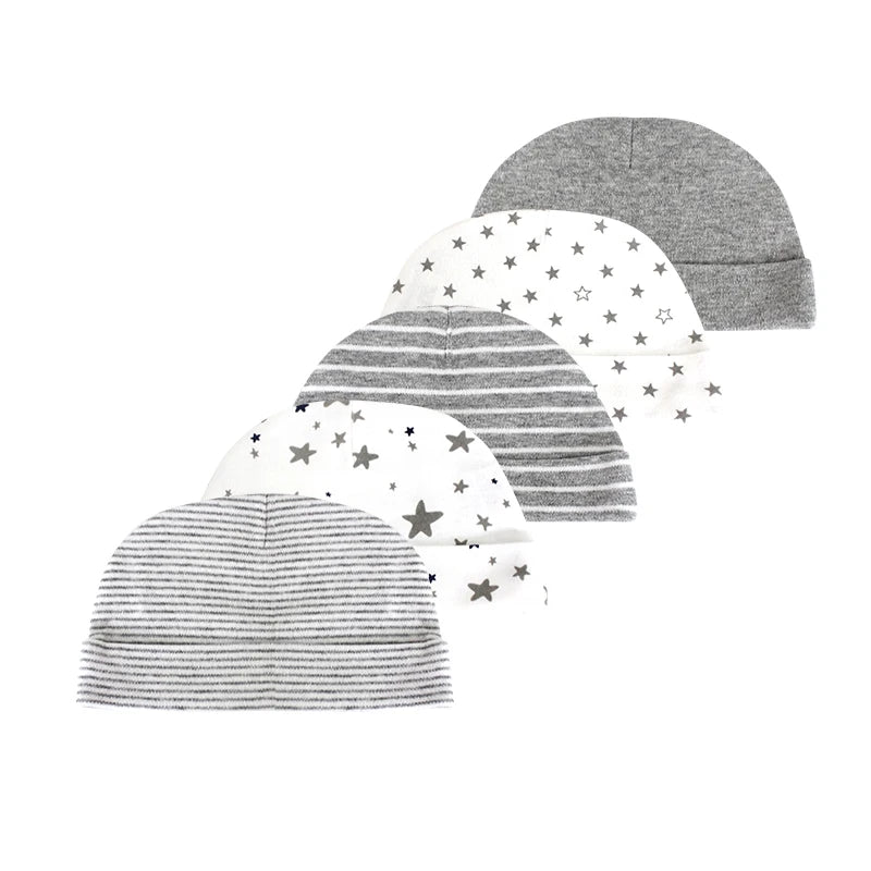A stack of five gray and white patterned baby hats for infants.