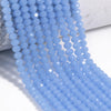A strand of light blue faceted crystal glass beads draped over a white surface.