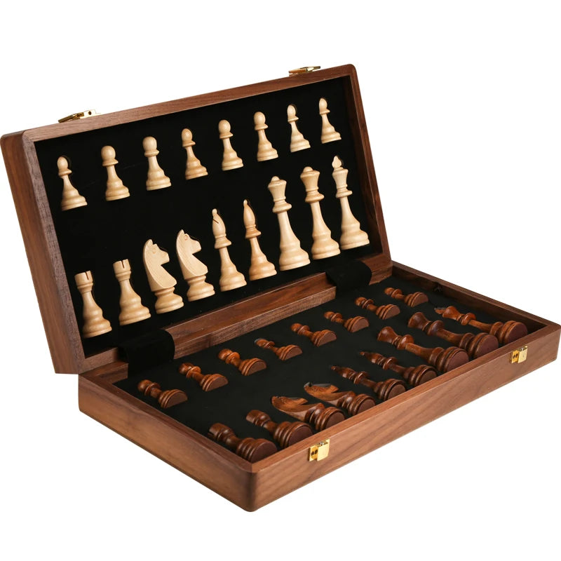 A handcrafted wooden folding chess set with solid walnut pieces displayed in a dark wood box.