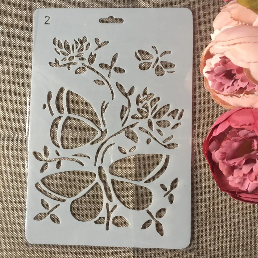 A white stencil featuring floral vine and butterfly designs for crafting projects.