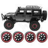 A black 1/10 RC crawler vehicle with beadlock wheels and a metal rack, shown alongside four replacement beadlock wheels.