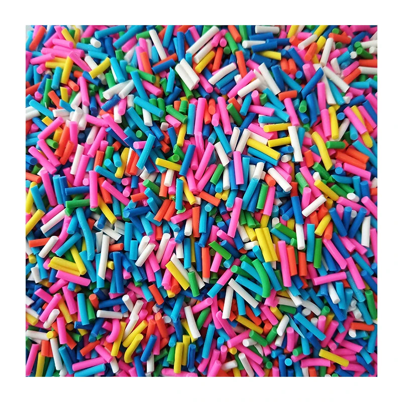 A close-up view of colorful soft polymer clay candy sprinkles in various bright colors like pink, blue, green, and yellow.