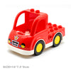 A red toy truck building block set with a trailer and various vehicles.