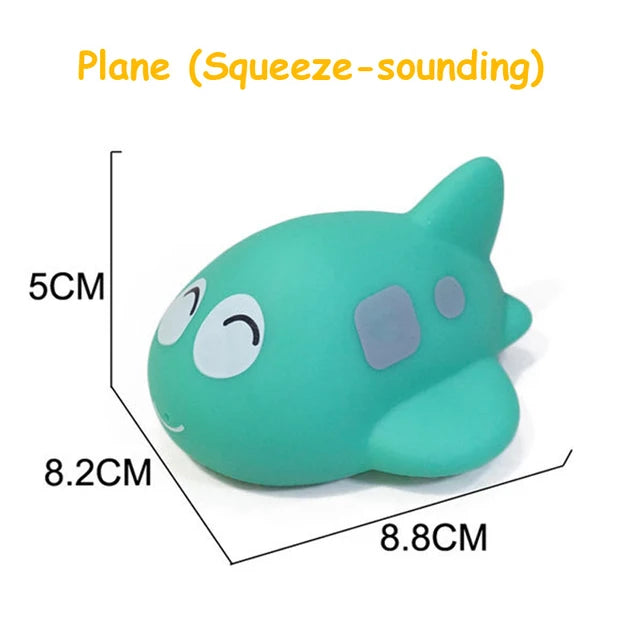 A light green cartoon soft rubber bath toy shaped like a fish, used for squeeze-sounding play.