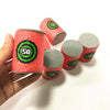 A hand holds several soft foam dart refills in red and gray packaging with green markings.