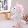 A white unicorn plush toy with pink accents sitting on a light-colored surface.
