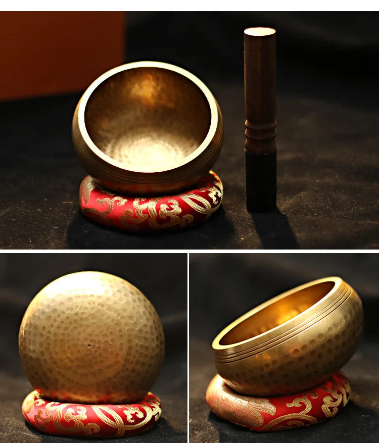 Handmade copper singing bowl with a mallet and a decorative red and gold base for meditation.