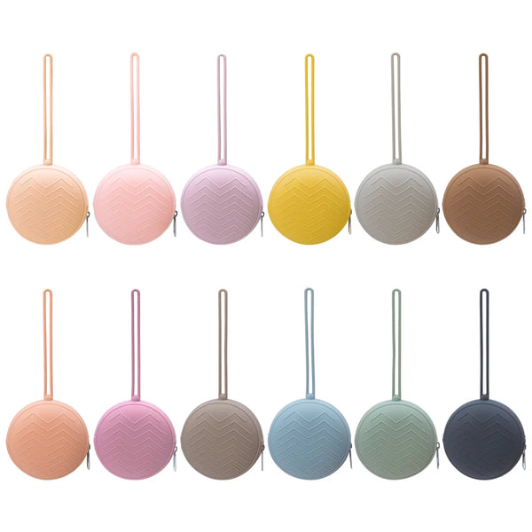 A set of eight soft silicone pacifier holders in various pastel and neutral colors.