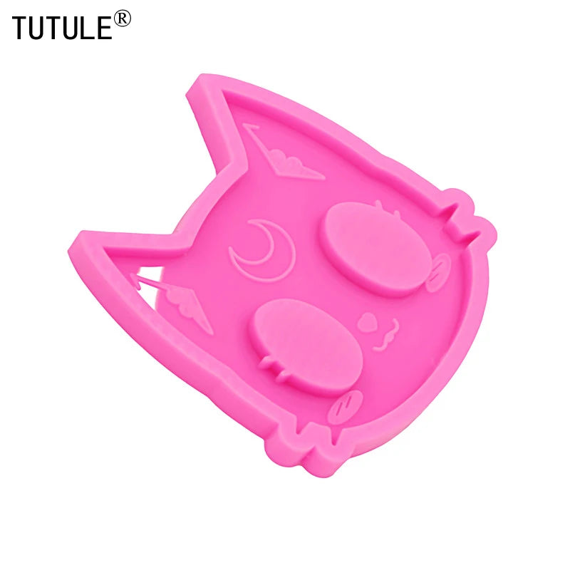 Pink silicone mold shaped like a cat head for DIY keychains and craft projects