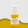 A small amber glass bottle of yellow liquid colorant labeled Lemon Yellow for DIY projects.