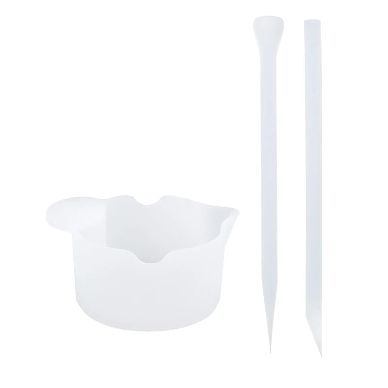 A white reusable silicone resin mixing tool kit with measuring cups and stir sticks.