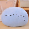 A soft, light blue plush toy pillow shaped like a cute anime slime character with closed eyes.