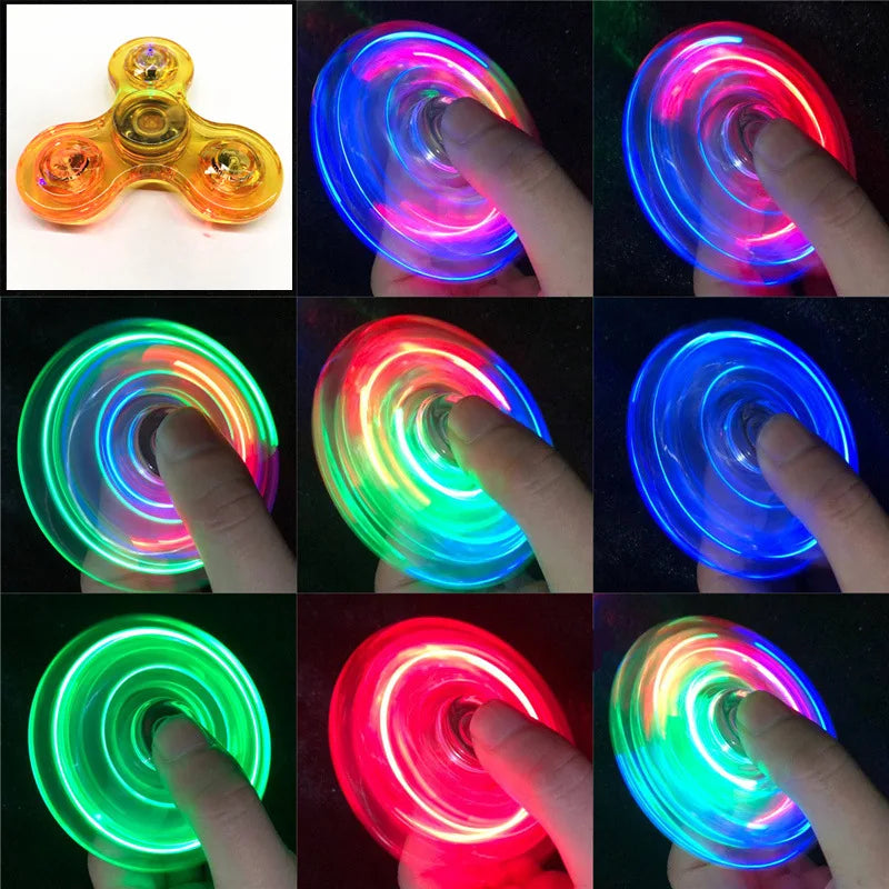 A collection of glow-in-the-dark LED fidget spinners demonstrating various colors and light effects.