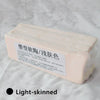 A rectangular block of light pink polymer clay for sculpting and doll making is shown on a white surface.