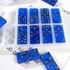 A silicone mold set for dominoes used in epoxy resin jewelry making featuring blue and gold colored pieces.