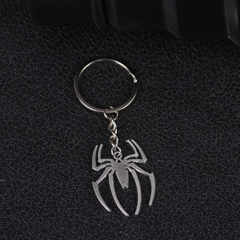 Silver pendant charm shaped like a spider on a keyring.