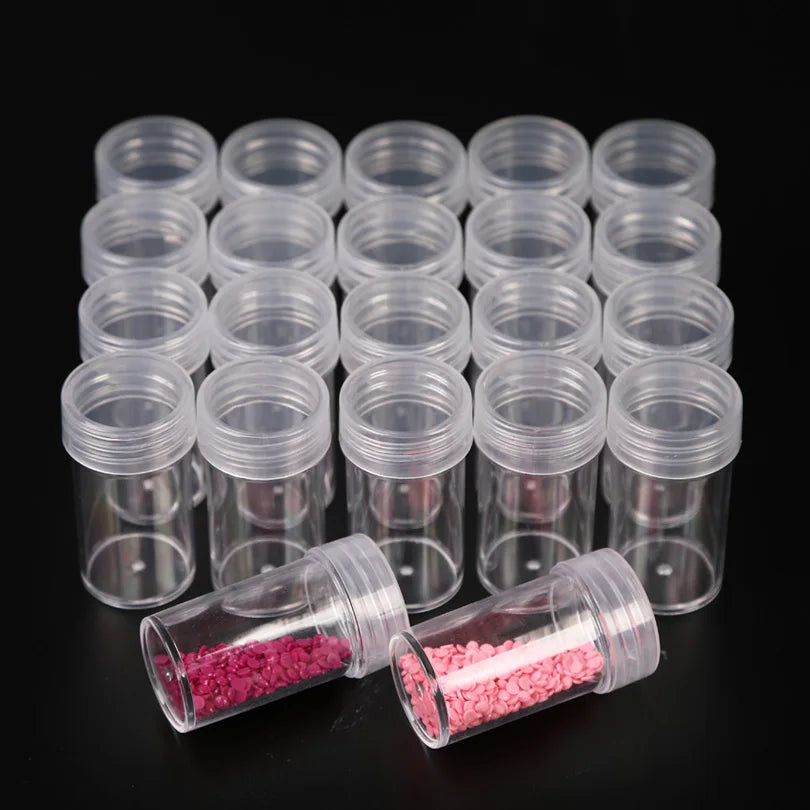 A collection of clear plastic storage bottles for diamond painting beads and crafts, arranged in rows.