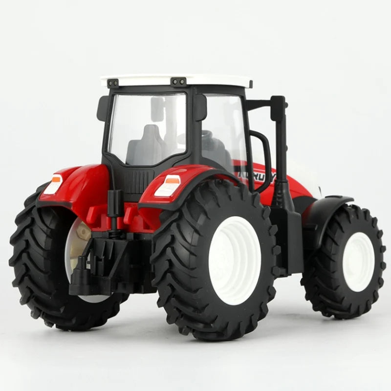 A red remote control tractor with a white cab, large tires, and a trailer is shown against a white background.