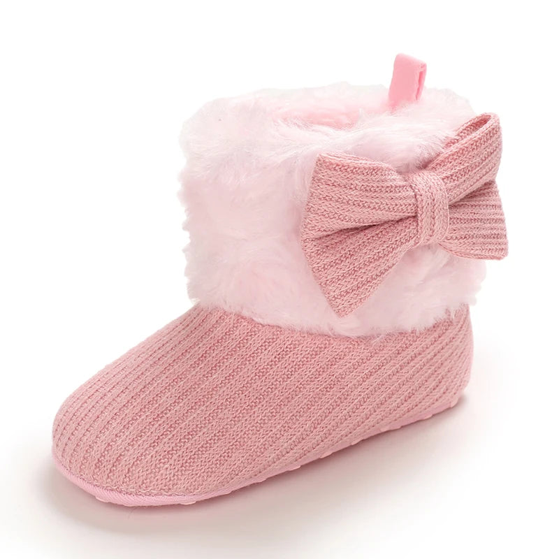 Pink plush baby snow boots for girls and boys with a bow detail
