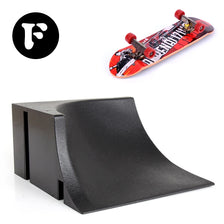 A finger skateboard park set featuring a skateboard and ramps, shown next to a black board component.