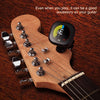 A clip-on chromatic tuner is mounted on a wooden guitar neck, showing the tuning mechanism and strings.