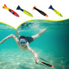 A person swimming underwater with a shark rocket toy visible near the surface.
