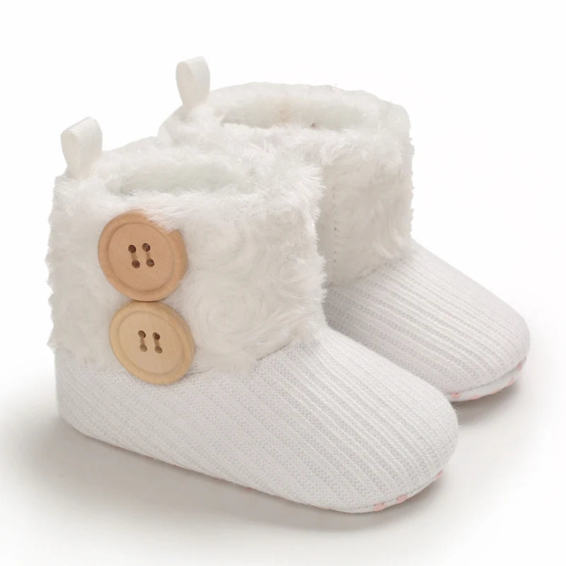 White plush baby snow boots for girls and boys with a textured sole