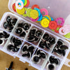 A clear plastic box filled with colorful plastic safety eyes for dolls and amigurumi