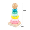 Stack of colorful wooden sensory blocks and music rattle on a light wooden base