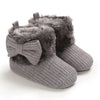 Gray knitted winter ankle boots for babies with faux fur trim and anti-slip soles