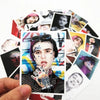 A hand holds a card featuring a portrait of Lil Peep with graffiti style markings and various stickers.