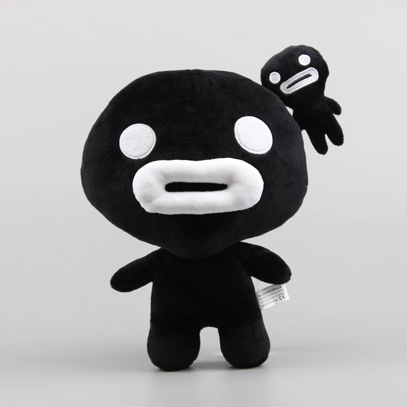 A black collectible plush toy resembling a stylized, round creature with white features and an appendage.