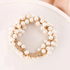 A crown-like wreath of small white pearls used as elegant hair ties or bow scrunchies.