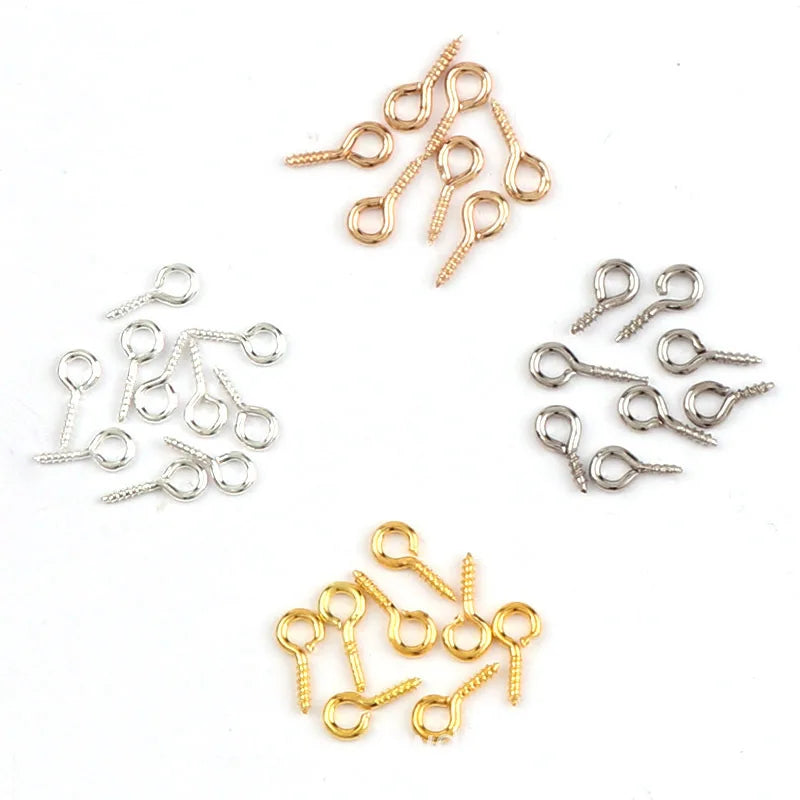 A collection of mini eye pins with screw threads for jewelry making in gold and silver finishes.