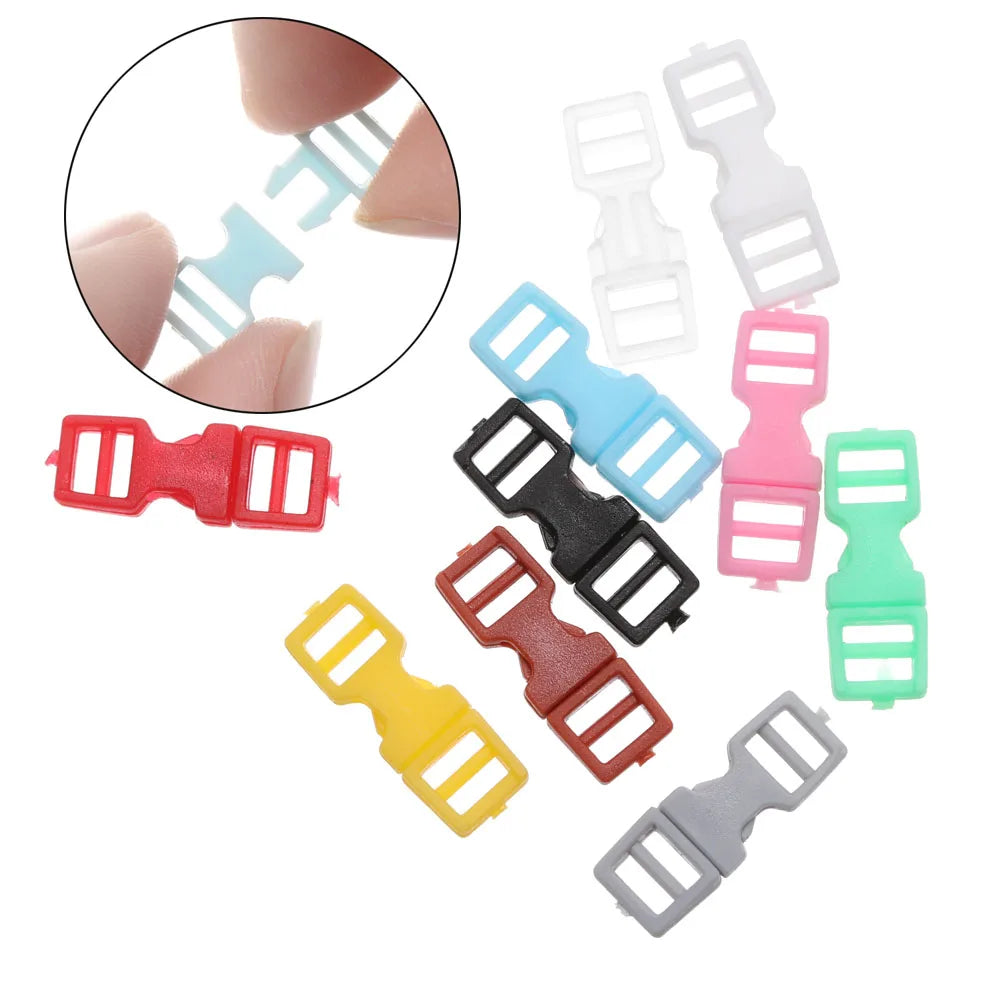 A collection of ten mini plastic buckles in various colors including blue, pink, red, green, and gray.