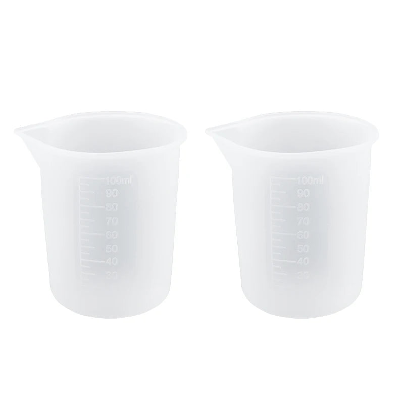 A pair of clear silicone resin mixing tool kit with measuring cups and stir sticks.
