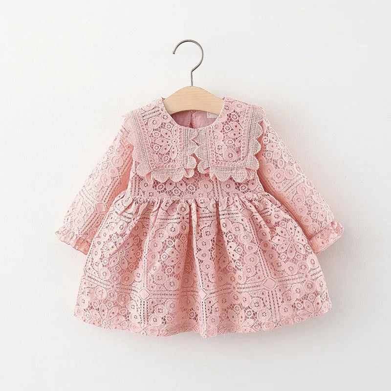 A pink lace princess dress for a toddler girl with a doll collar, displayed on a hanger.