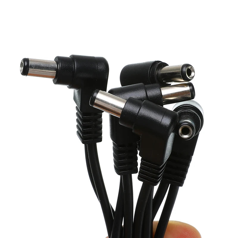 A bundle of black guitar pedal daisy chain cables with various connectors and a 3/4/5/6-way output.