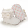White plush baby snow boots for girls and boys with a polka dot fabric interior