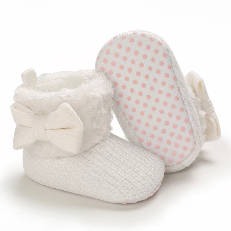 White plush baby snow boots for girls and boys with a polka dot fabric interior
