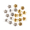 A collection of small, antique gold and silver Tibetan style hollow flower bead caps for jewelry making.