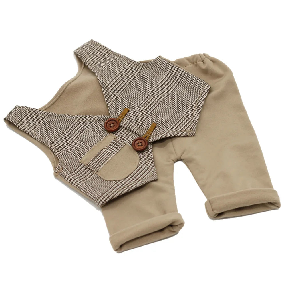 A beige newborn photography outfit set featuring a plaid vest and matching long-sleeved pants.