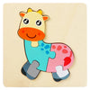 A colorful wooden puzzle of a cartoon yellow and pink animal, resembling a young bovine.