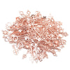 A pile of vintage rose gold metal key charms for DIY jewelry making