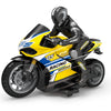 A black and yellow 1:10 scale remote control stunt motorcycle with a rider in full gear.