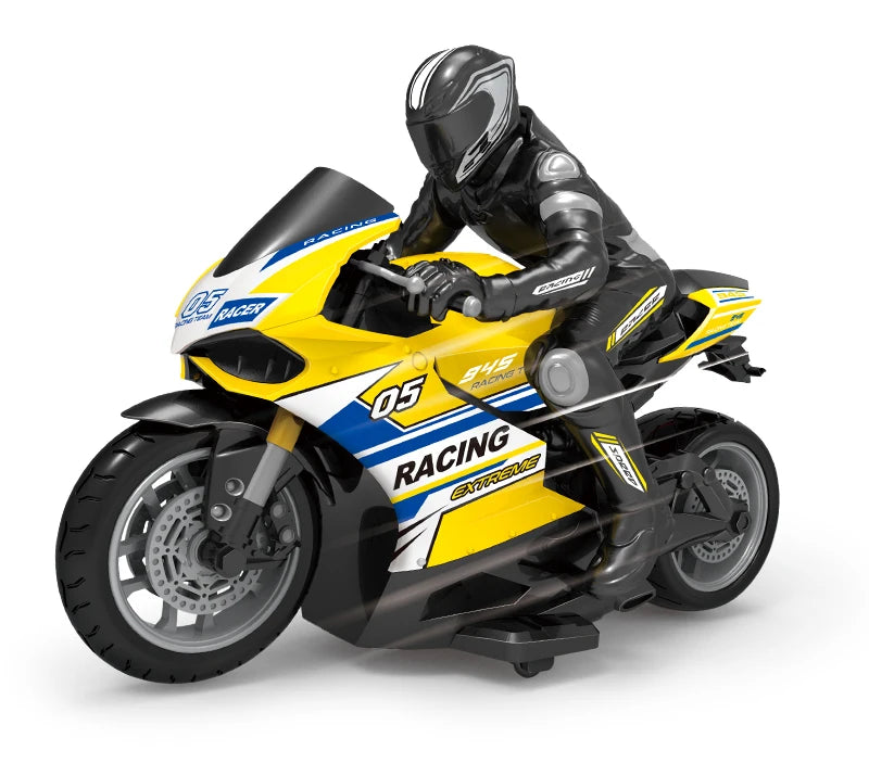 A black and yellow 1:10 scale remote control stunt motorcycle with a rider in full gear.
