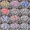 A grid of 12 ceramic beads in various colors and patterns for jewelry making